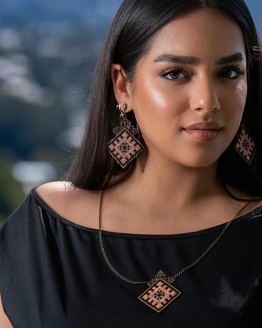 Model wearing the Luna embroidered necklace and matching earrings